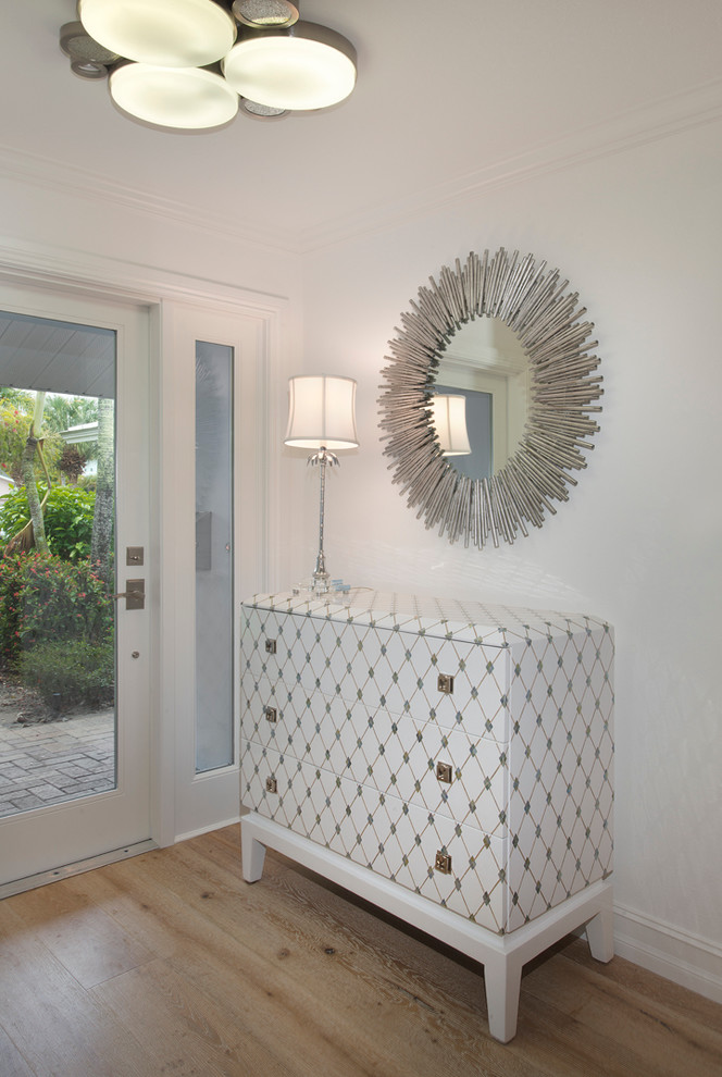 Example of a mid-sized transitional entryway design in Miami with white walls and a white front door