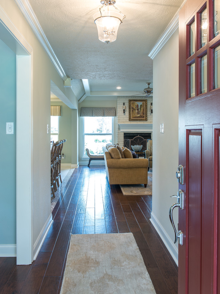 Medium sized traditional front door in Houston with beige walls, medium hardwood flooring, a single front door and a red front door.