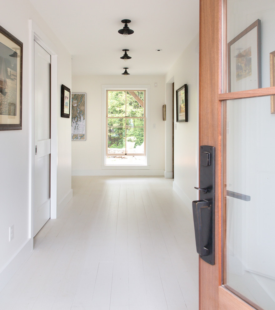 Design ideas for a medium sized modern front door in Portland Maine with white walls, painted wood flooring, a single front door and a dark wood front door.