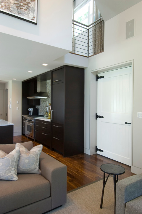 Inspiration for a mid-sized transitional medium tone wood floor entryway remodel in New York with white walls and a white front door