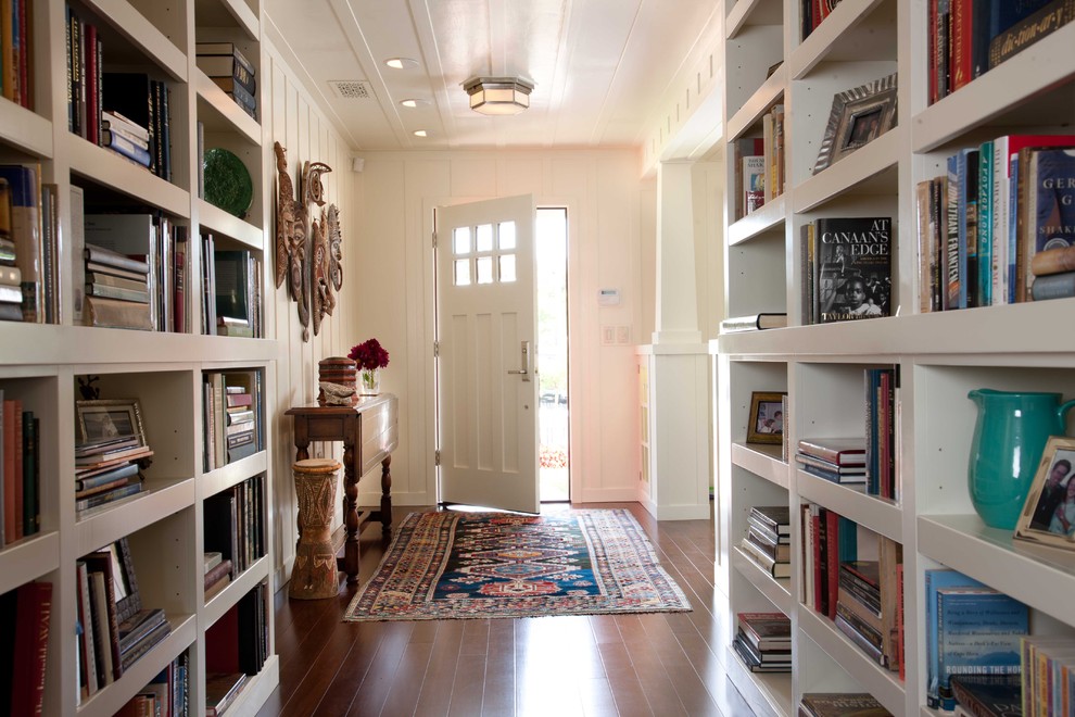 Inspiration for a mid-sized timeless dark wood floor and brown floor entryway remodel in San Diego with white walls and a red front door