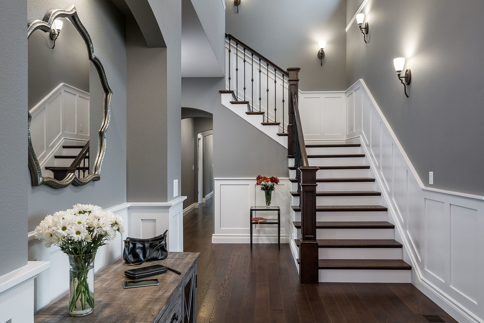 Inspiration for a large craftsman dark wood floor and brown floor foyer remodel in Other with gray walls