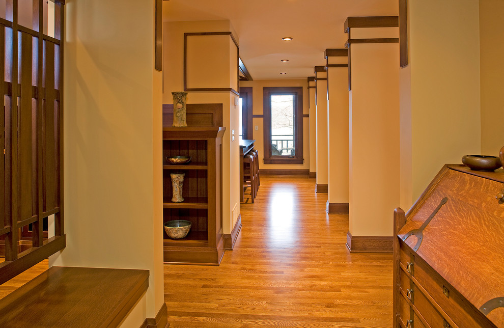 Inspiration for a medium sized classic hallway in Minneapolis with beige walls, medium hardwood flooring and a medium wood front door.