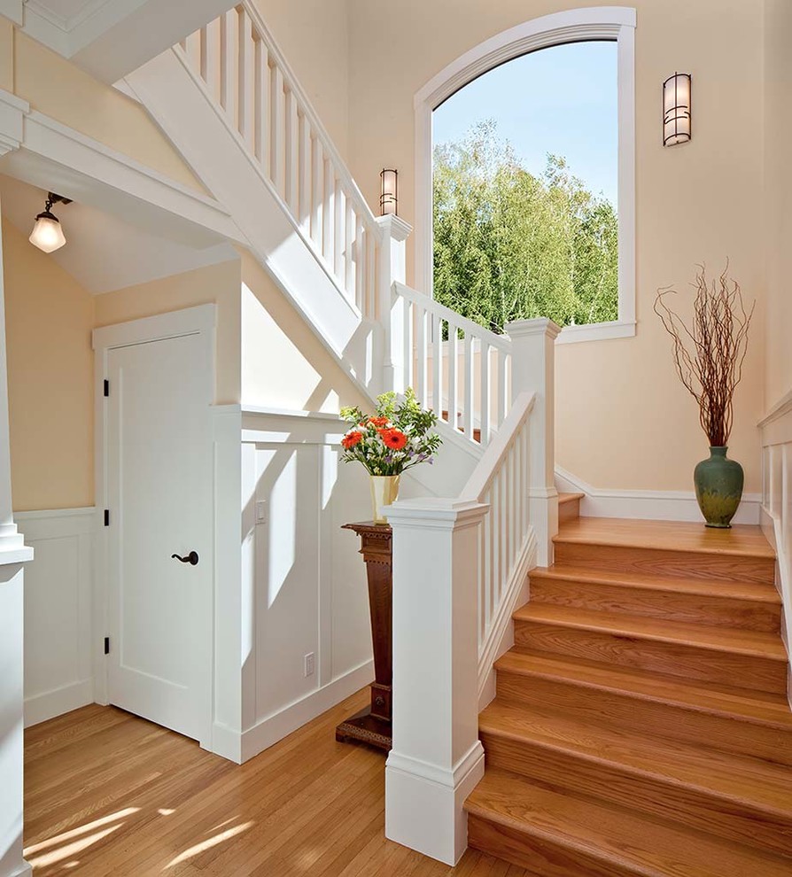 Example of a huge arts and crafts light wood floor entryway design in San Francisco with yellow walls
