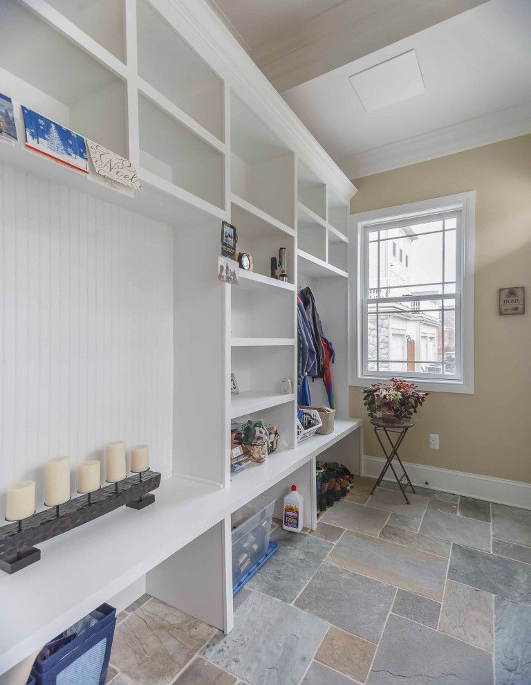 Photo of a medium sized classic boot room in Detroit with beige walls, slate flooring, a single front door, a white front door, multi-coloured floors, a wallpapered ceiling, wallpapered walls and feature lighting.