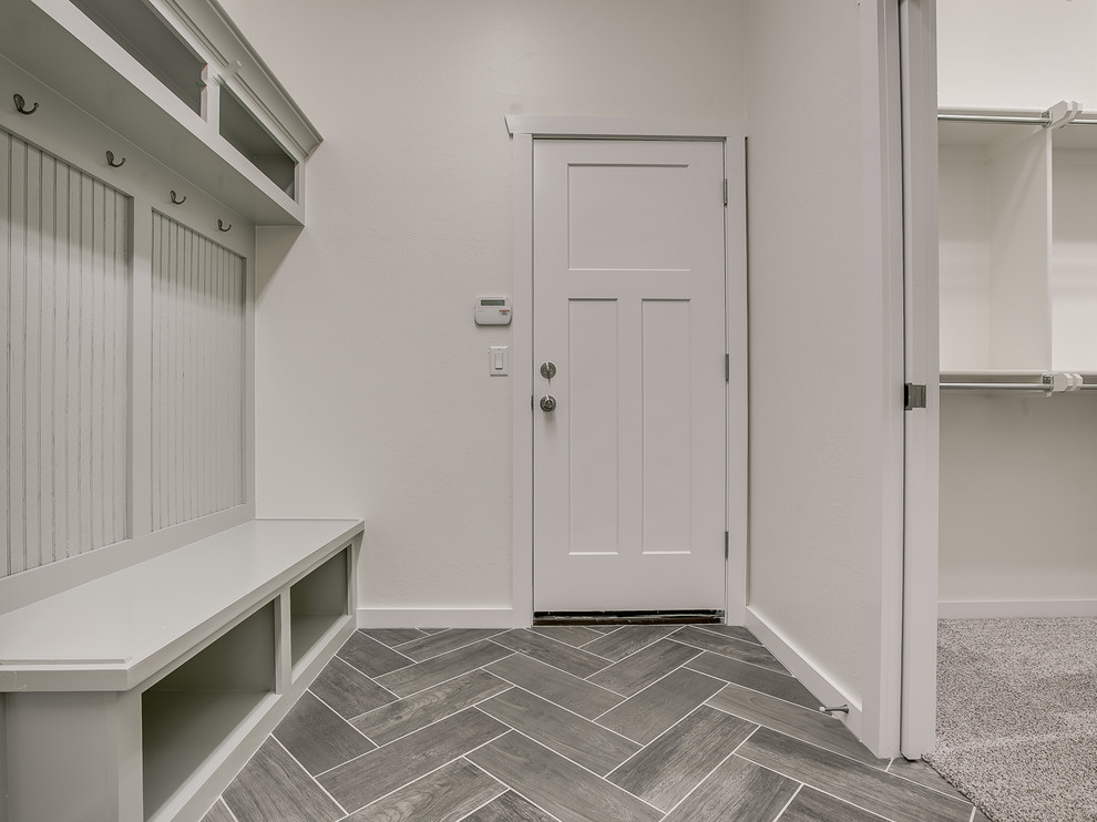 Inspiration for a medium sized classic boot room in Oklahoma City with grey walls, a single front door, a white front door, ceramic flooring and black floors.