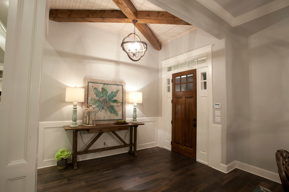 Large arts and crafts medium tone wood floor entryway photo in Austin with gray walls
