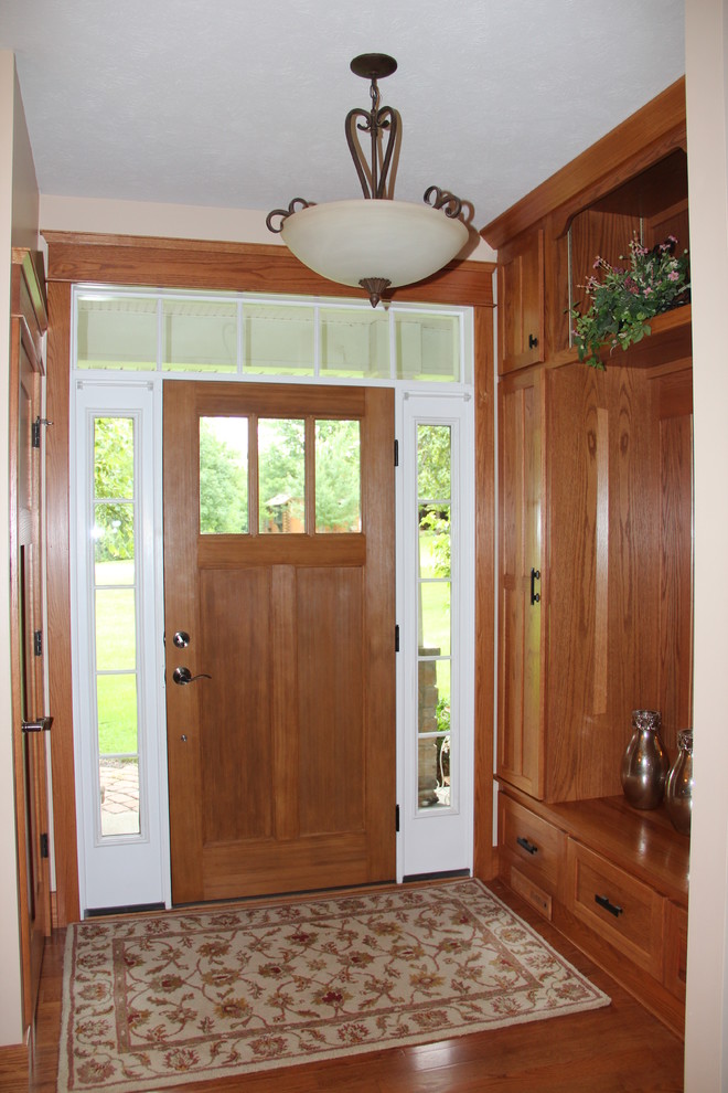 Photo of a traditional entrance in Chicago with light hardwood flooring.