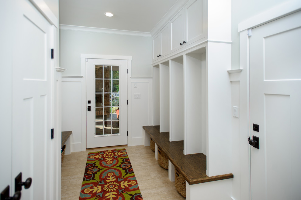 Large arts and crafts limestone floor entryway photo in Bridgeport with gray walls and a white front door