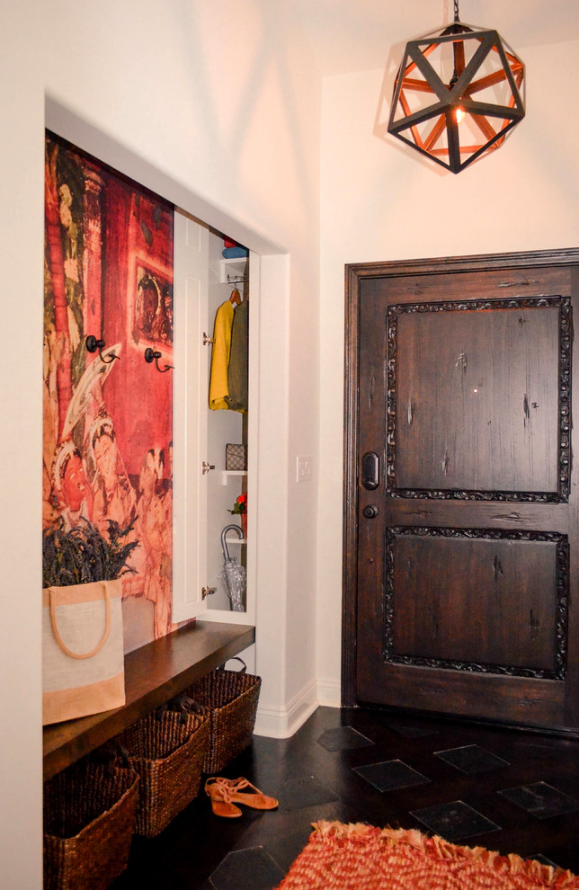 Example of a large tuscan dark wood floor and brown floor entryway design in Los Angeles with white walls and a dark wood front door