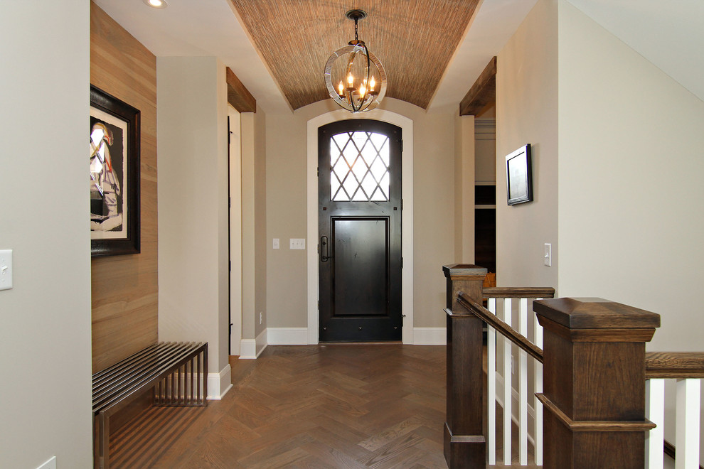 Example of a mid-sized transitional dark wood floor entryway design in Minneapolis with beige walls and a dark wood front door