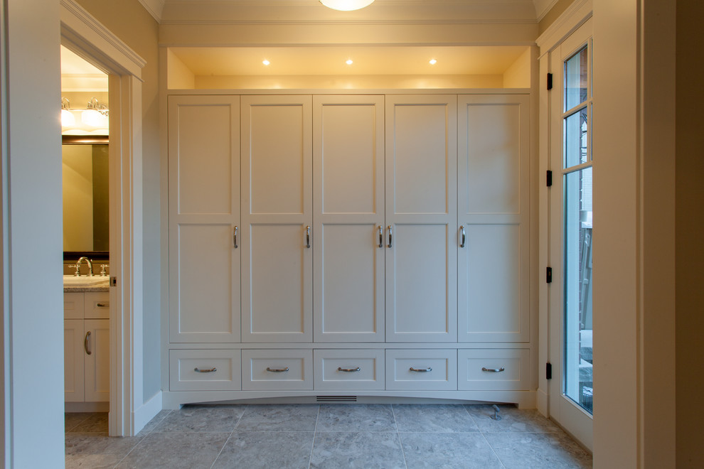 Modelo de vestíbulo posterior clásico de tamaño medio con paredes blancas, suelo de baldosas de porcelana y puerta pivotante