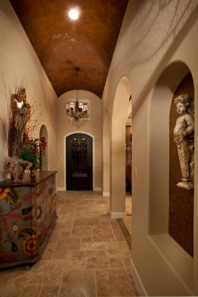 Photo of a medium sized mediterranean foyer in Austin with beige walls, travertine flooring, a single front door and a metal front door.