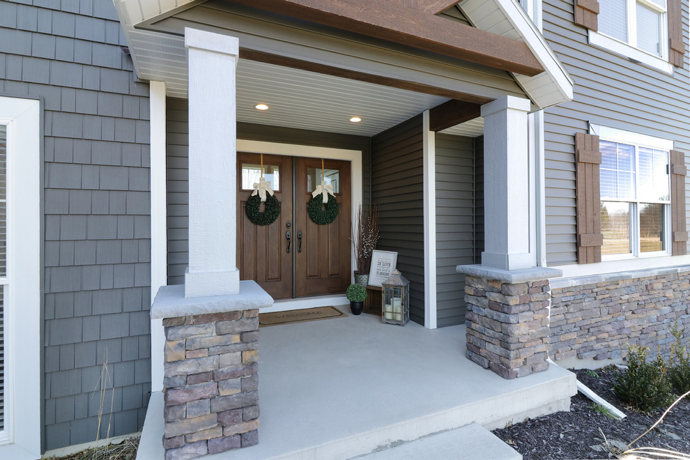 Design ideas for a medium sized traditional front door in Grand Rapids with grey walls, a double front door and a dark wood front door.