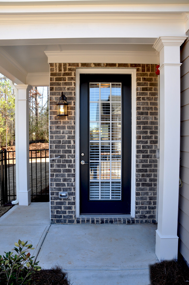 Example of a large trendy entryway design in Atlanta with a brown front door