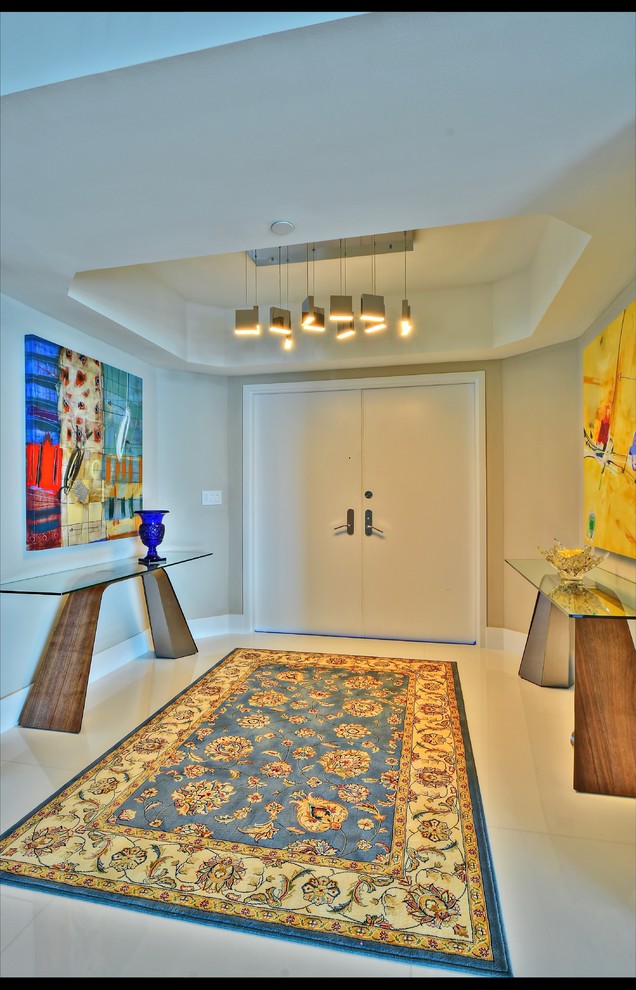 Example of a mid-sized trendy porcelain tile entryway design in Miami with beige walls and a white front door