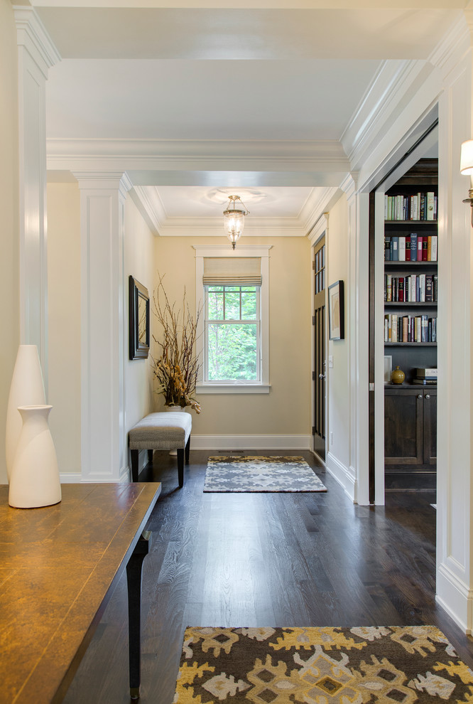 Design ideas for a classic hallway in Minneapolis with beige walls, dark hardwood flooring, a single front door and a brown front door.