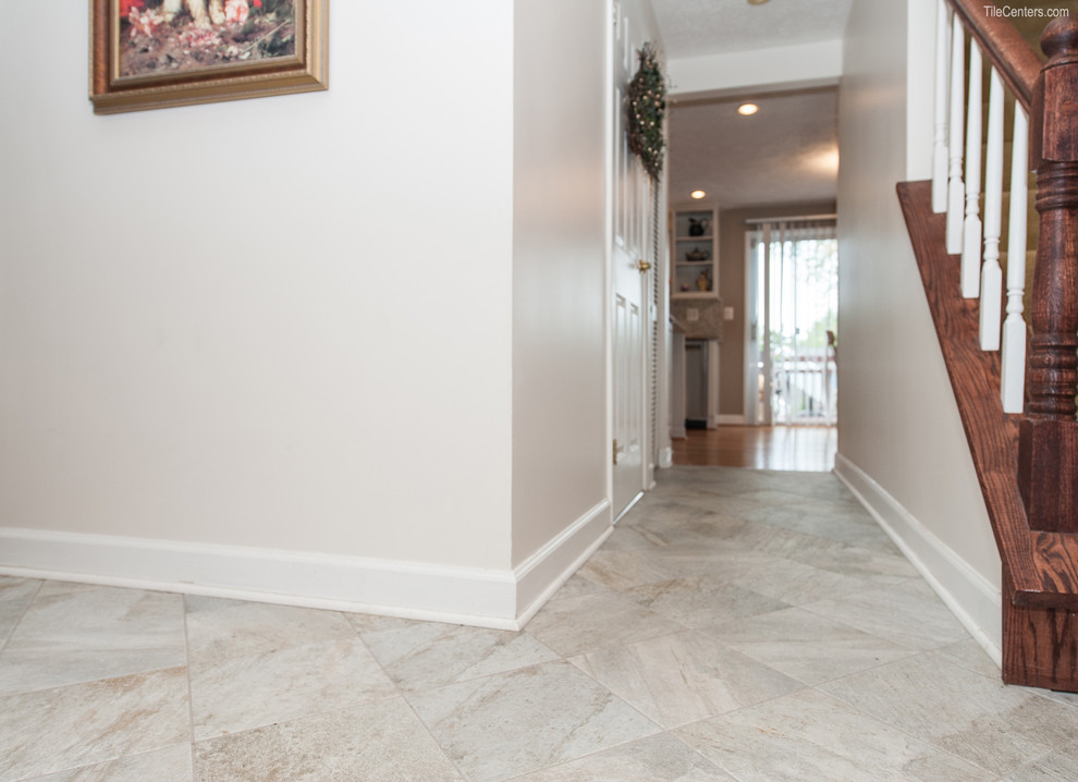 This is an example of a medium sized traditional foyer in DC Metro with porcelain flooring.