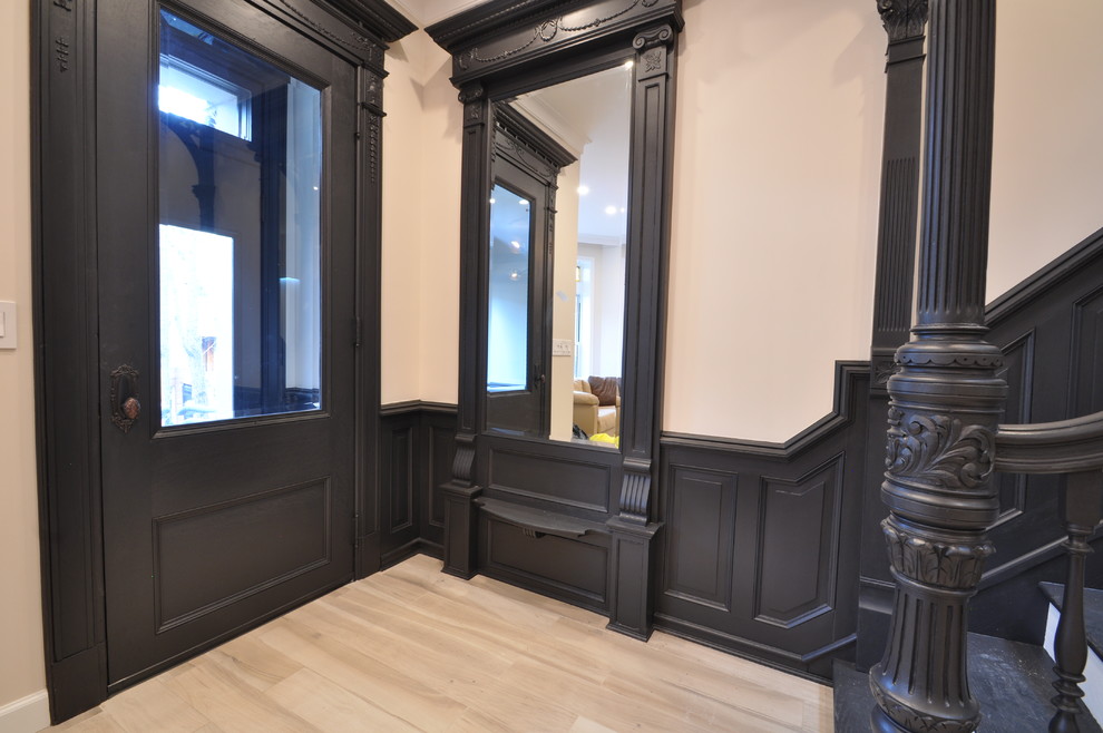 Kleine Klassische Haustür mit Einzeltür, schwarzer Haustür, beiger Wandfarbe und hellem Holzboden in New York