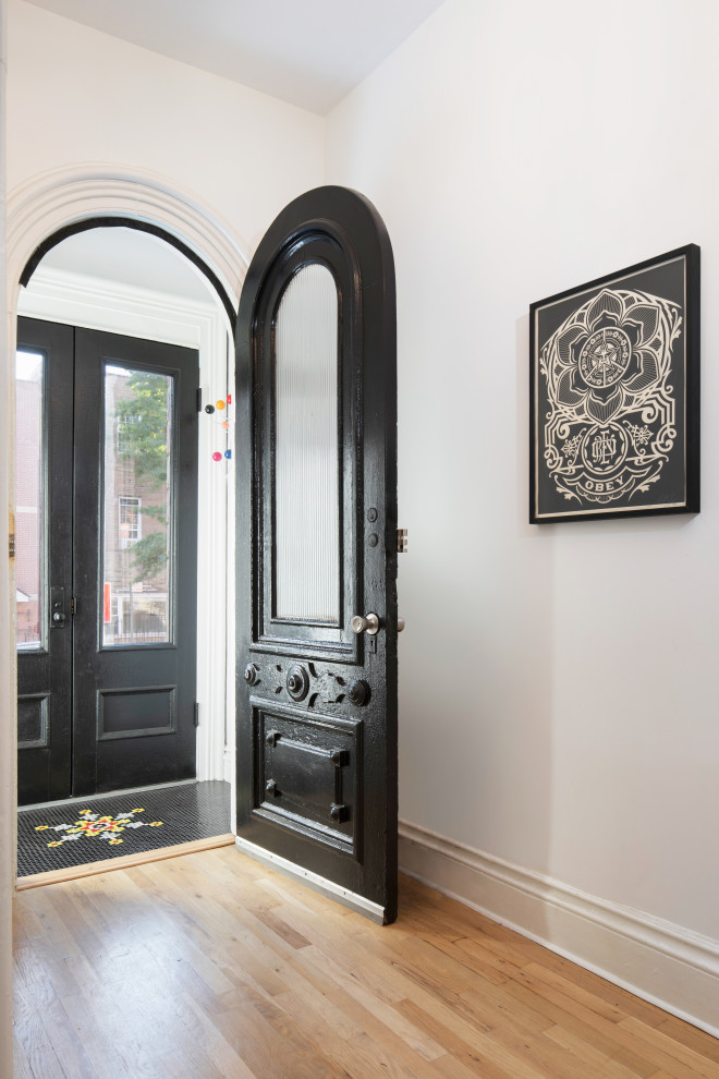 Contemporary foyer in New York with porcelain flooring, a double front door and a black front door.