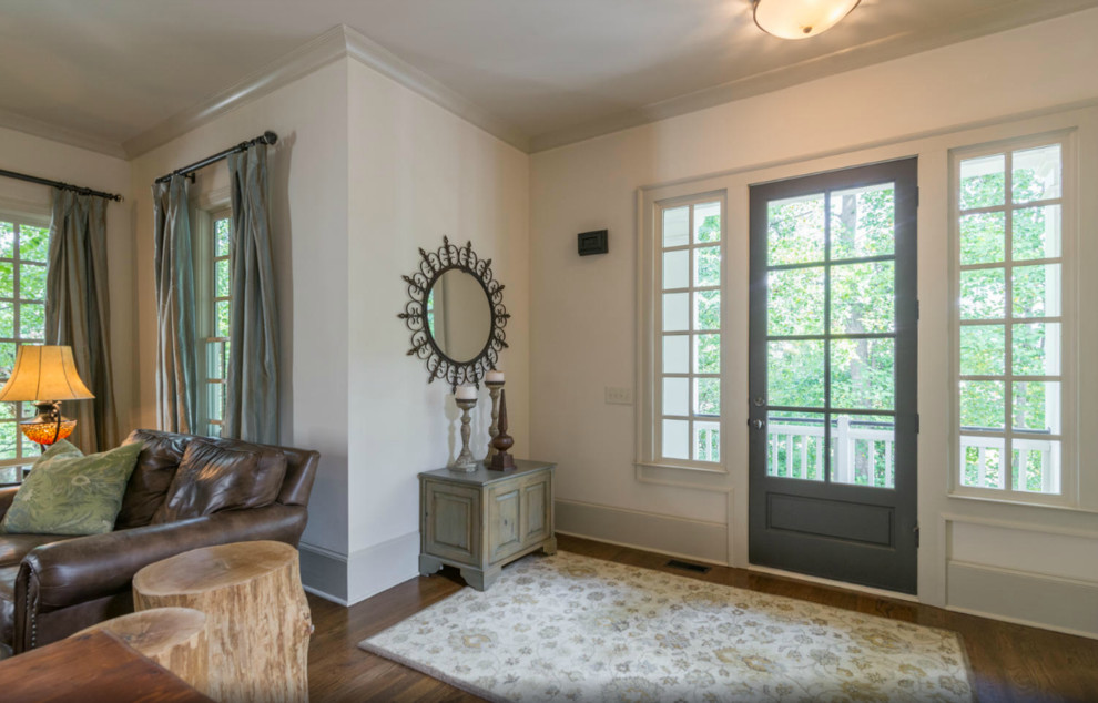 Inspiration for a small craftsman medium tone wood floor entryway remodel in Atlanta with beige walls and a gray front door