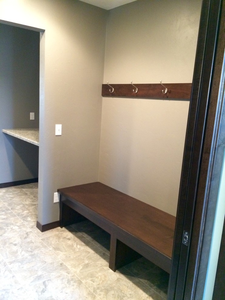 Photo of a medium sized classic boot room in Other with beige walls and vinyl flooring.
