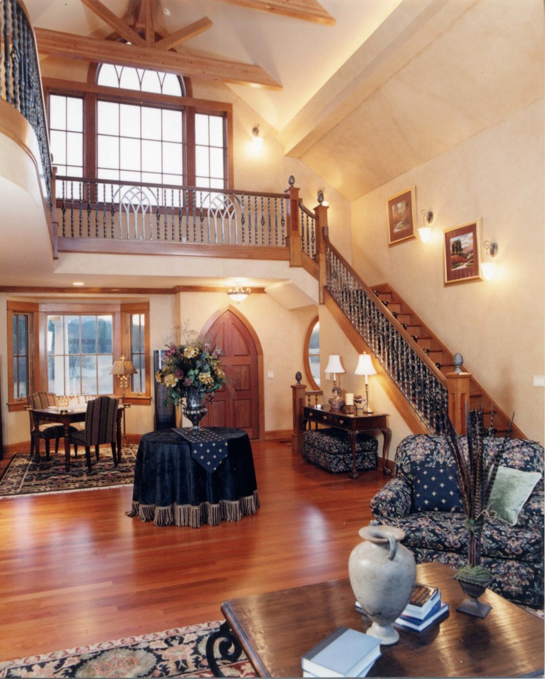 Example of a large classic medium tone wood floor entryway design in Seattle with beige walls and a medium wood front door