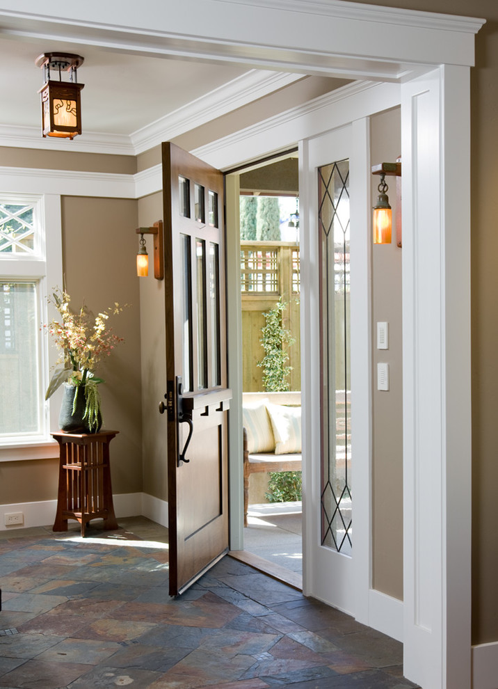 Inspiration for a craftsman slate floor single front door remodel in San Diego with brown walls and a dark wood front door