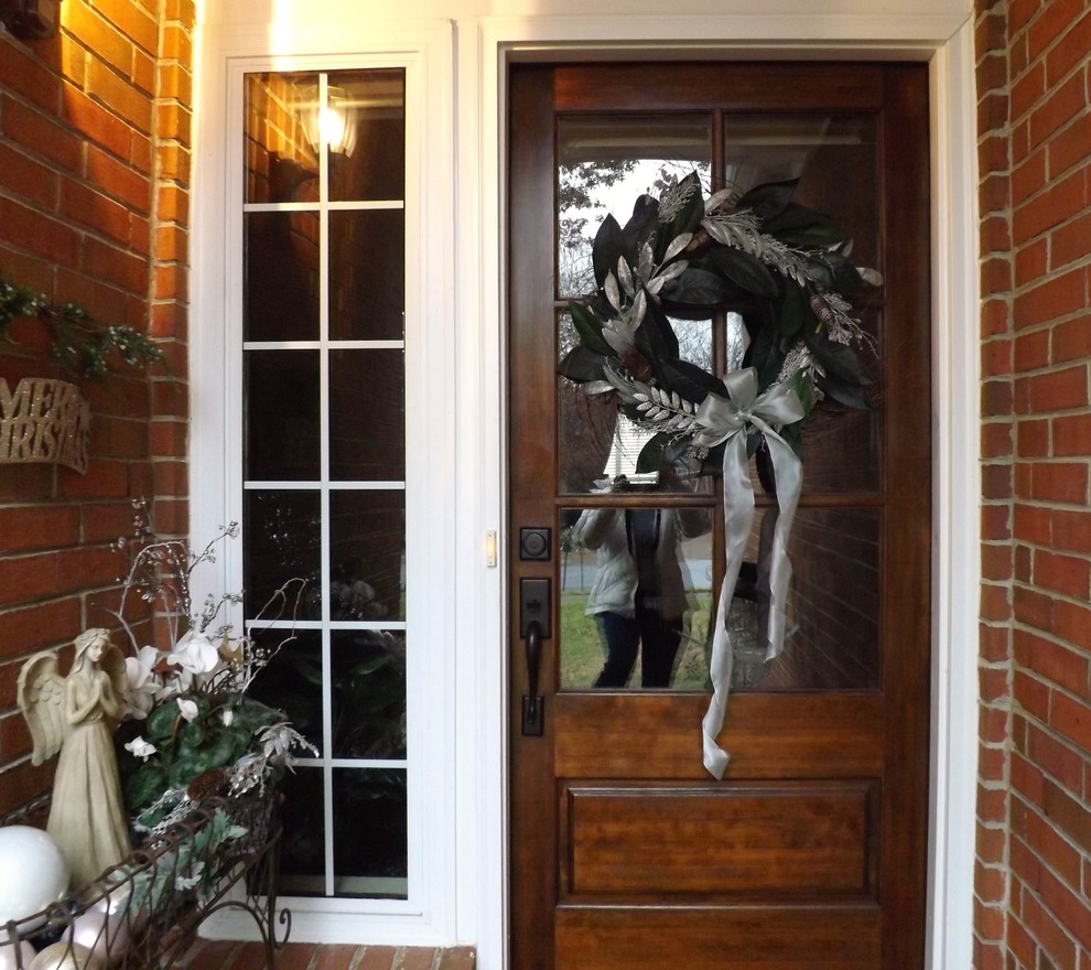 Inspiration for a small traditional entrance in Nashville with black walls, brick flooring, a single front door and a medium wood front door.