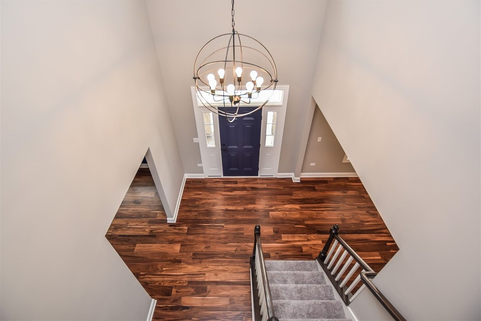 This is an example of a medium sized classic foyer in Chicago with grey walls, dark hardwood flooring, a single front door, a blue front door and brown floors.