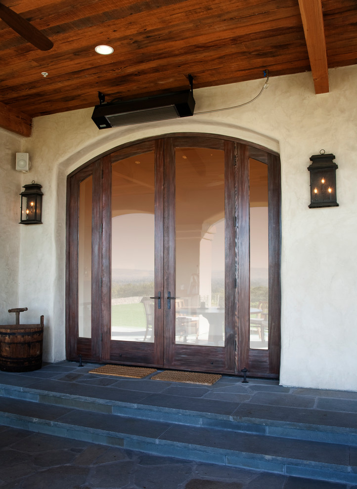 Mid-sized country slate floor entryway photo in San Francisco with beige walls and a dark wood front door