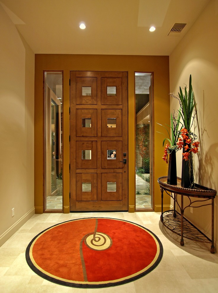 Foto di una porta d'ingresso design di medie dimensioni con pavimento in gres porcellanato, una porta singola e una porta in legno bruno