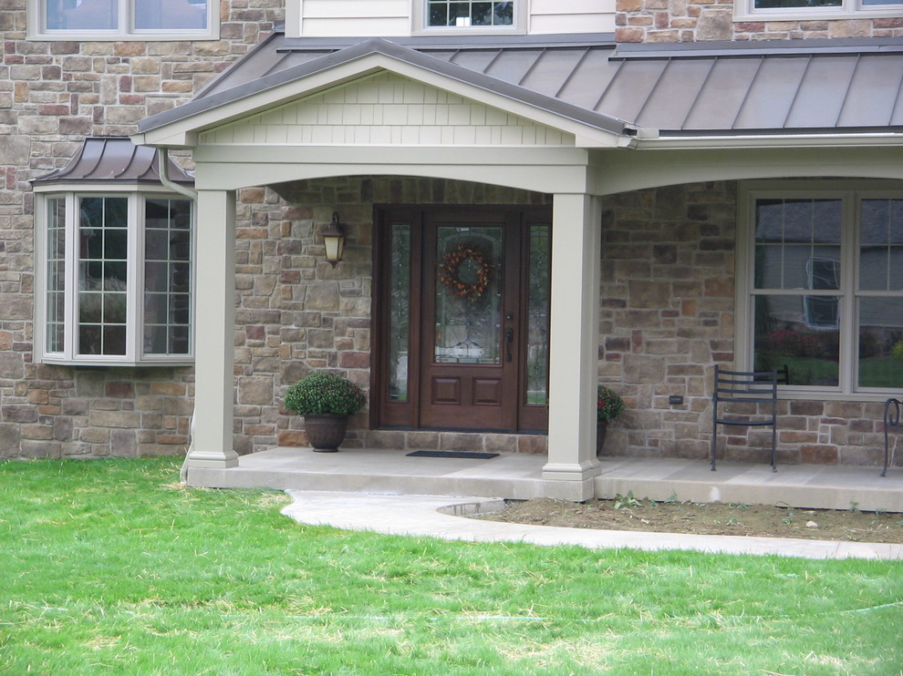 Medium sized traditional front door in Philadelphia with brown walls, concrete flooring, a single front door, a dark wood front door and grey floors.