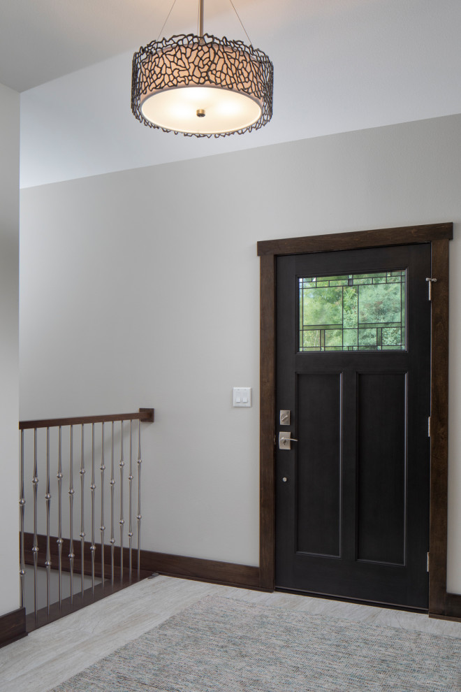 Imagen de puerta principal de estilo americano de tamaño medio con paredes grises, suelo laminado, puerta simple, puerta negra y suelo gris