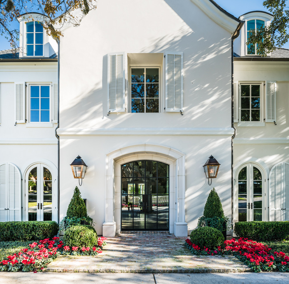 This is an example of a large traditional entrance in Austin with white walls, a double front door and a glass front door.