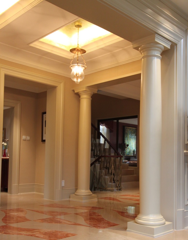 Large elegant marble floor entry hall photo in St Louis with beige walls
