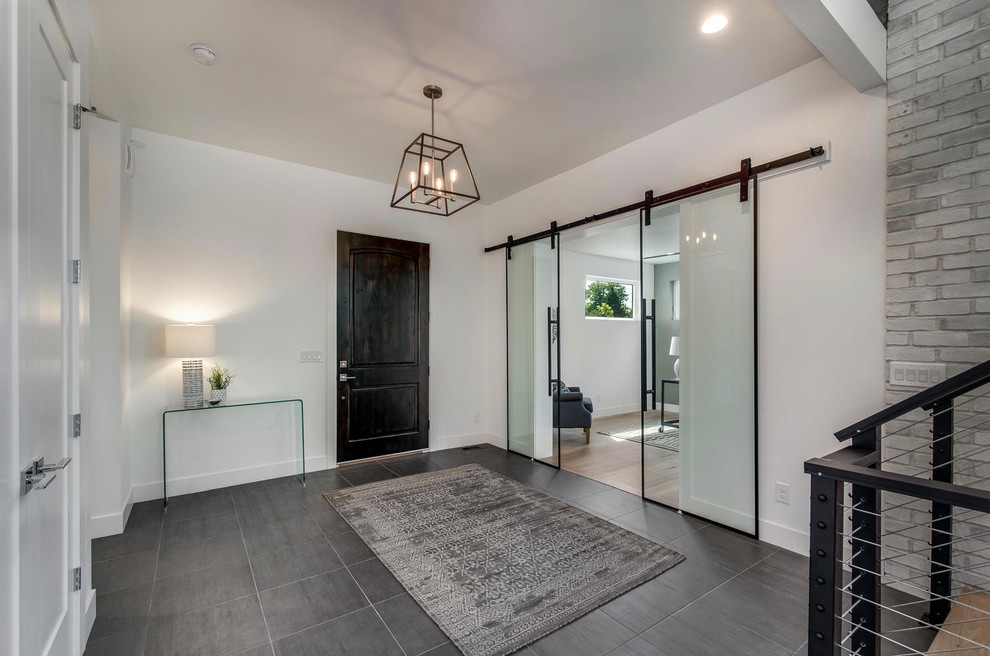 Large contemporary foyer in Denver with white walls, porcelain flooring, a single front door, a dark wood front door and grey floors.