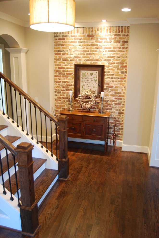 Example of a mid-sized classic dark wood floor and brown floor entryway design in Atlanta with beige walls