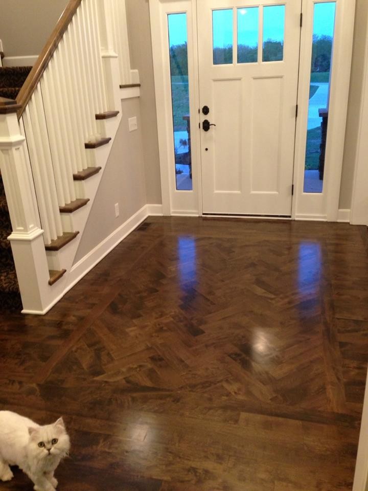 Mid-sized arts and crafts dark wood floor entryway photo in Kansas City with gray walls and a white front door