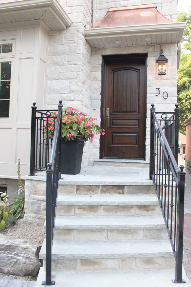 Inspiration for a small classic front door in Toronto with a single front door and a dark wood front door.