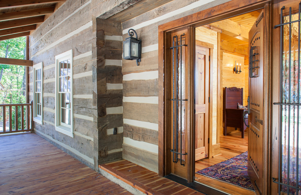 Photo of a large rustic front door in Other with a single front door and a medium wood front door.