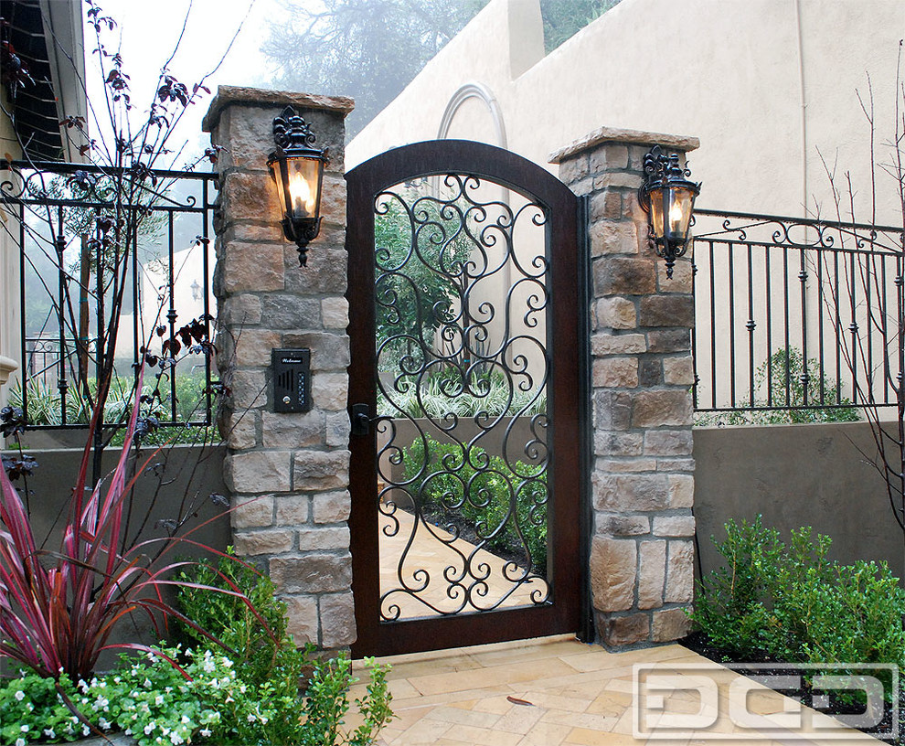 This is an example of a medium sized mediterranean front door in Los Angeles with a single front door and a metal front door.