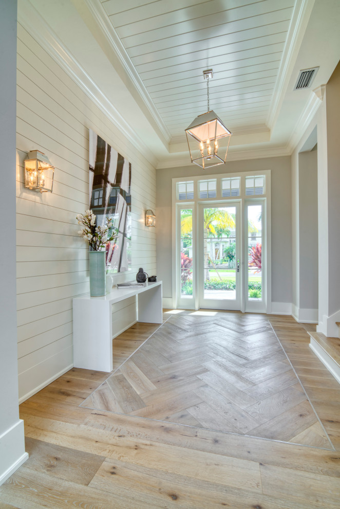Design ideas for a classic foyer in Miami with beige walls, medium hardwood flooring, a single front door, a glass front door, brown floors, a timber clad ceiling, a drop ceiling and tongue and groove walls.