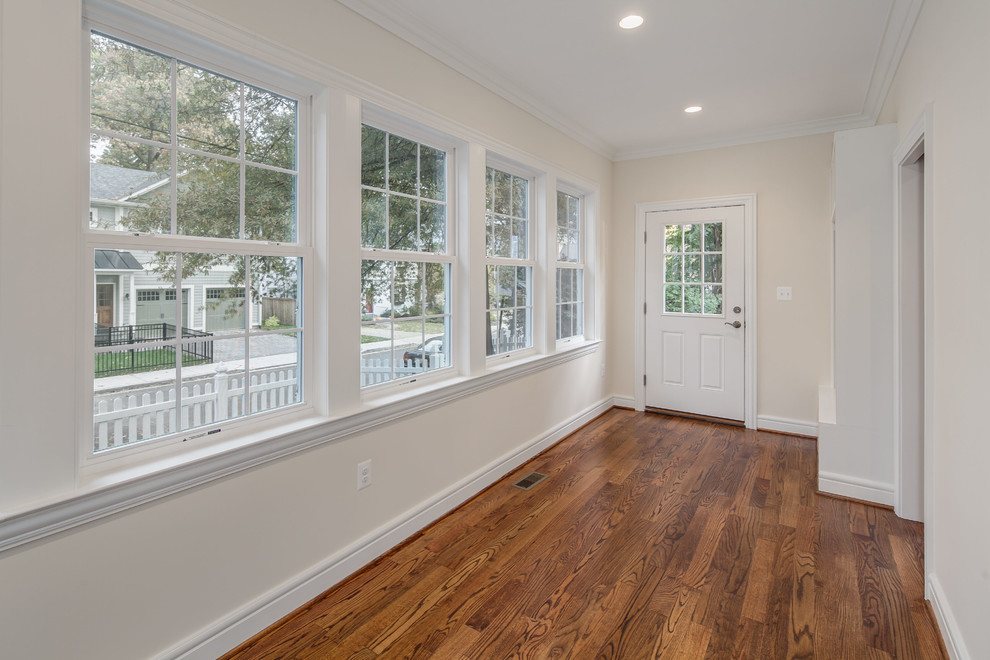 Mid-sized transitional medium tone wood floor entryway photo in DC Metro with beige walls and a white front door