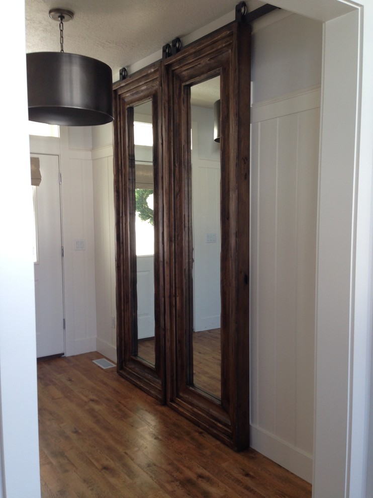 Example of an arts and crafts dark wood floor entryway design in Salt Lake City with white walls