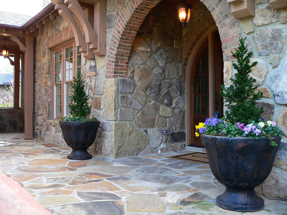 Example of a mid-sized classic limestone floor and multicolored floor entryway design in Atlanta with multicolored walls and a dark wood front door