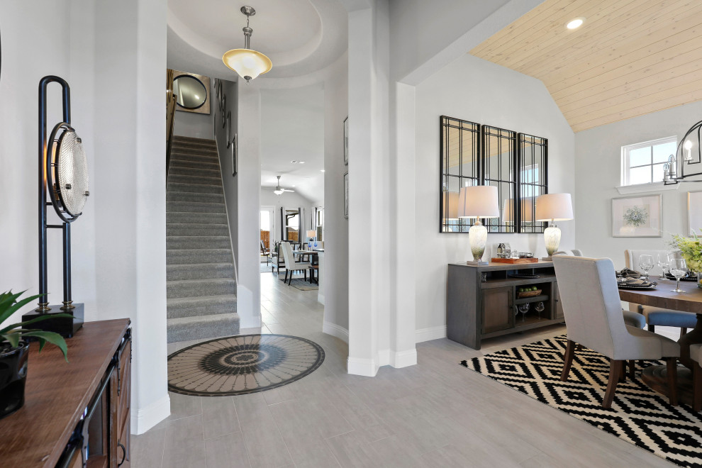 This is an example of a medium sized contemporary foyer in Dallas with white walls, light hardwood flooring, a pivot front door, a black front door and beige floors.