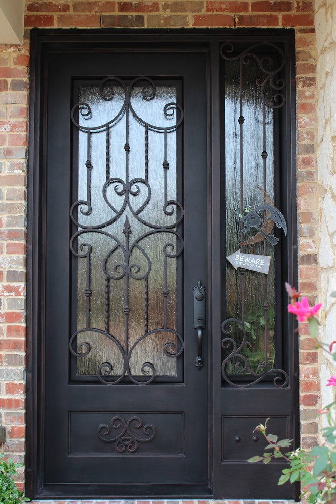 Elegant entryway photo in Dallas with a metal front door