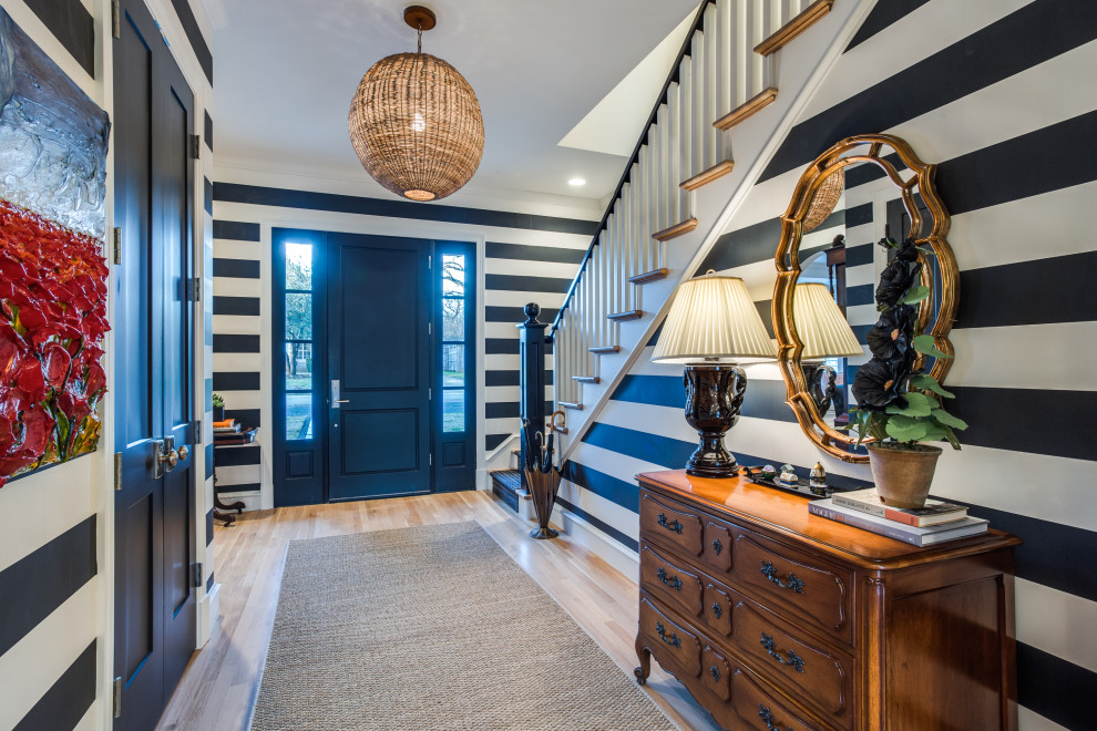 Inspiration for a coastal wallpaper foyer remodel in Dallas with multicolored walls and a black front door