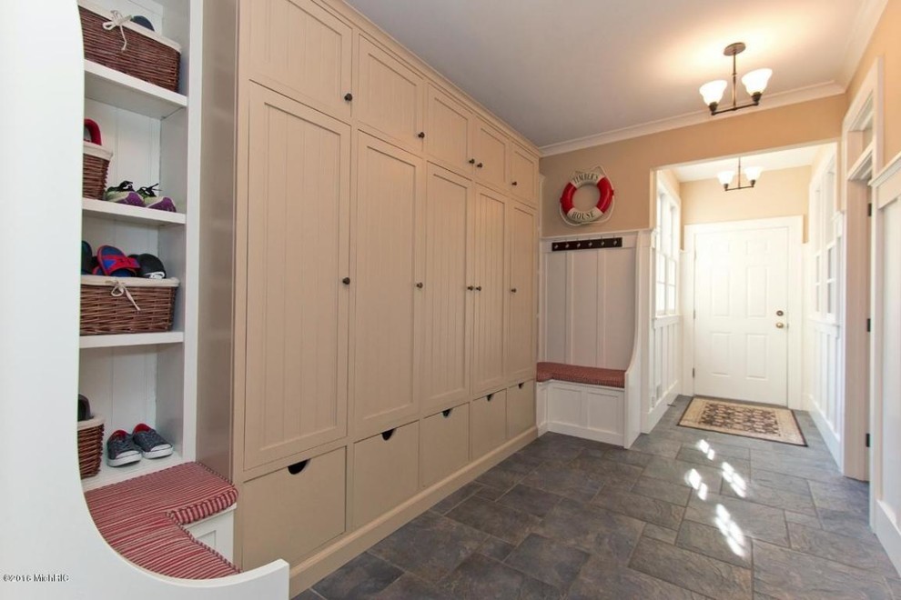 Photo of a large farmhouse boot room in Grand Rapids with beige walls, slate flooring, a single front door, a white front door and blue floors.